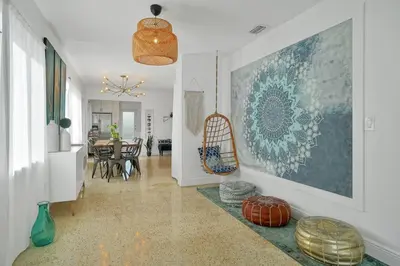 a living room with a large painting on the wall at Buddha House Pool Big Yard in Miami