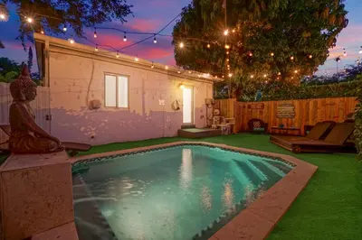 a small swimming pool in a yard with lights at Buddha House Pool Big Yard in Miami