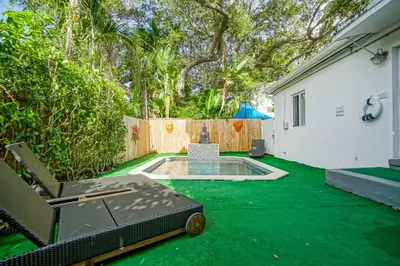a backyard with a small pool and green grass at Buddha House Pool Big Yard in Miami