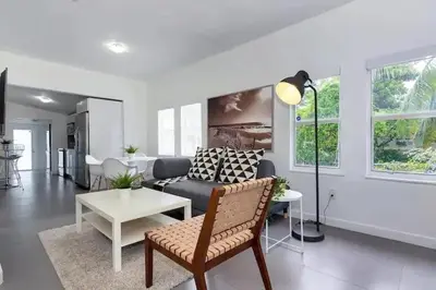 a living room with a couch and a table at Wynwood House With Pool, Hotub and Parking in Miami