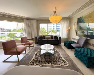 a living room with a couch and a table at North Beach Hotel in Fort Lauderdale