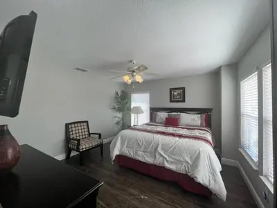 a bedroom with a bed and a ceiling fan at Stunning 4BR Oasis with Pool, 14 minutes to the Ocean in Hollywood