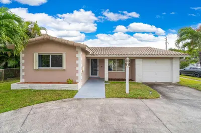 a house with a driveway in front of it at Stunning 4BR Oasis with Pool, 14 minutes to the Ocean in Hollywood