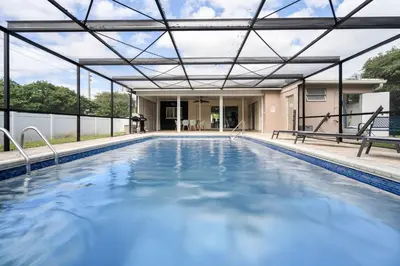 an indoor swimming pool with a roof over it at Stunning 4BR Oasis with Pool, 14 minutes to the Ocean in Hollywood