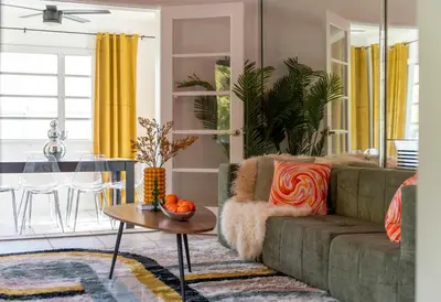 a living room with a couch and a table at Retro Rewind - Location parking and all the vibes in Miami