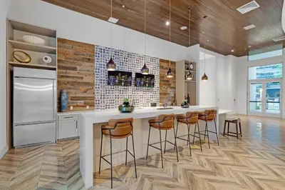 a kitchen with a large island with bar stools at Comfort and Convenience 2BR Unit with Free Parking in Miami
