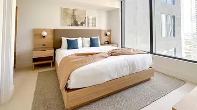 a bedroom with a bed and a large window at Stylish One Bedroom in the heart of vibrant Downtown- Daily resort fee and parking not included in Miami