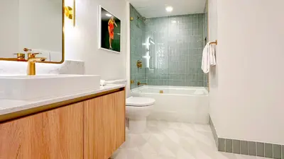 a bathroom with a sink and a toilet and a tub at Stylish One Bedroom in the heart of vibrant Downtown- Daily resort fee and parking not included in Miami