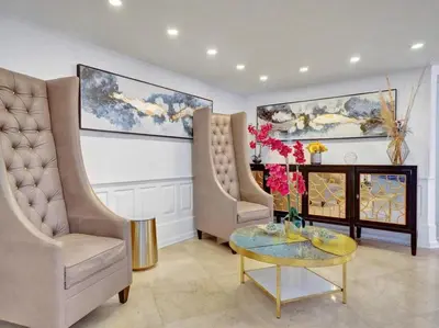 a living room with two chairs and a table at Luxury 2BD Penthouse with Beach Access and Resort Amenities PH6 in Miami Beach