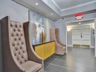 a room with two chairs and a table and a painting at Luxury 2BD Penthouse with Beach Access and Resort Amenities PH6 in Miami Beach