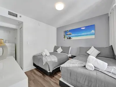 a living room with a couch and a bed at Luxury Beach Condo with Exclusive Resort Amenities 1016 in Miami Beach
