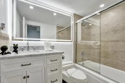 a bathroom with a shower and a toilet and a sink at Comfortable 2-Bedroom Condo Retreat with Resort Facilities 1108 in Miami Beach