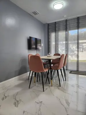 a dining room with a table and chairs at 2-bed Lakeridge Fllfree Parking 6 Min To Beach in Fort Lauderdale
