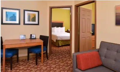 a hotel room with a bedroom with a bed and a desk at Candlewood Suites Miami - Doral by IHG in Tamiami
