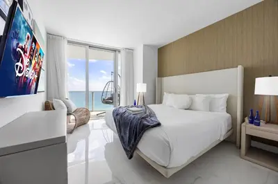 a bedroom with a large bed and a large window at Ventur Beachfront Luxe Condo - Lyfe Beach Resort in Hollywood