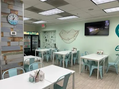 a dining room with tables and chairs in a restaurant at 1 bedroom with amazing ocean view in Hollywood