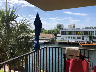 an umbrella sitting on a balcony overlooking a body of water at Golden Isles Suite 315 in Hallandale Beach