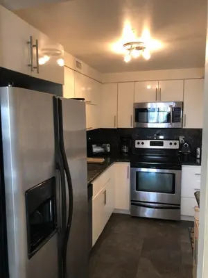 a kitchen with a stainless steel refrigerator and appliances at Golden Isles Suite 315 in Hallandale Beach