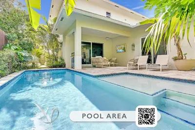 a swimming pool in front of a house at The Secret Garden - Stunning Luxurious Villa in Fort Lauderdale in Fort Lauderdale