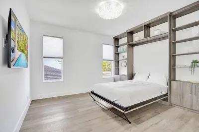 a bedroom with a bed and a window at The Secret Garden - Stunning Luxurious Villa in Fort Lauderdale in Fort Lauderdale