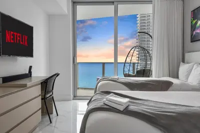 a hotel room with three beds and a view of the ocean at Ventur Luxe Condo l Oceanview - Gym, Beach Access in Hollywood