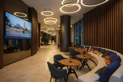 a restaurant with tables and chairs and a flat screen tv at Ventur Luxe Condo l Oceanview - Gym, Beach Access in Hollywood