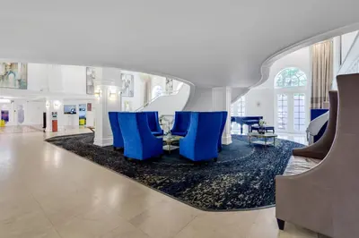 a lobby with blue chairs and a table at Huge Beachfront 2400sqft 5 Bedroom 5 Bathroom with Ocean View in Miami Beach