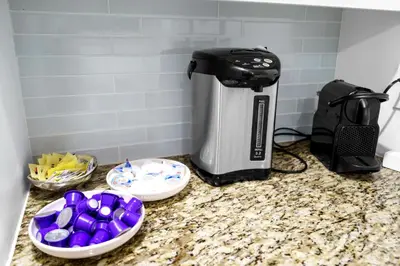 a coffeemaker sitting on a counter with three bowls ofwered at Huge Beachfront 2400sqft 5 Bedroom 5 Bathroom with Ocean View in Miami Beach
