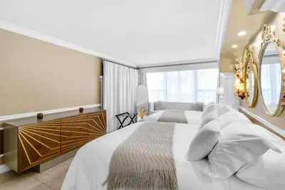 a bedroom with a large bed and a mirror at Huge Beachfront 2400sqft 5 Bedroom 5 Bathroom with Ocean View in Miami Beach