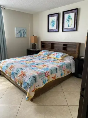 a bedroom with a bed and two pictures on the wall at Spectacular ocean view 1 bedroom in Hollywood in Hollywood
