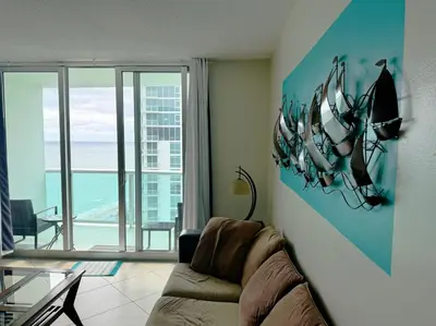 a living room with a couch and a view of the ocean at Spectacular ocean view 1 bedroom in Hollywood in Hollywood