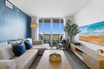 a living room with a couch and a table at Modern Stylish 2BR with Balcony in Hallandale Beach