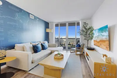 a living room with a couch and a table at Modern 1BR with Pool & Balcony in Hallandale Beach