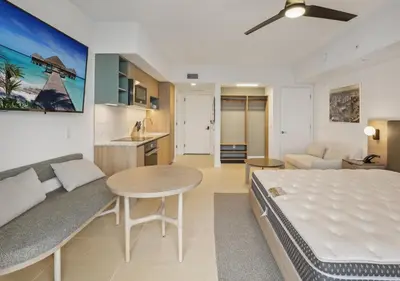 a bedroom with a bed and a table and a couch at NEW Luxury Bay View Downtown Studio in Miami