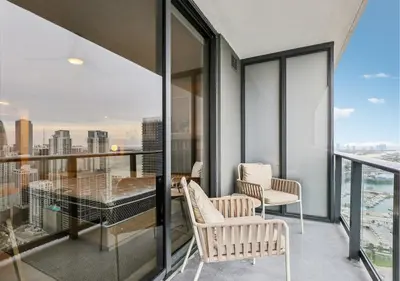 a balcony with a table and chairs on a building at NEW Luxury Bay View Downtown Studio in Miami