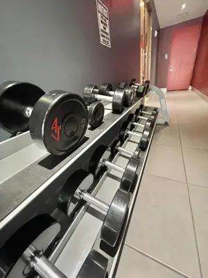 a row of dumbbells lined up in a gym at Luxury Suite on Beachwalk with Pool Gym & Beach in Hallandale Beach