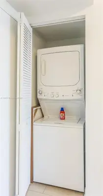 a microwave oven sitting on top of a refrigerator at 1 Bdm & Kitchen at Beachwalk Pool Gym Beach in Hallandale Beach
