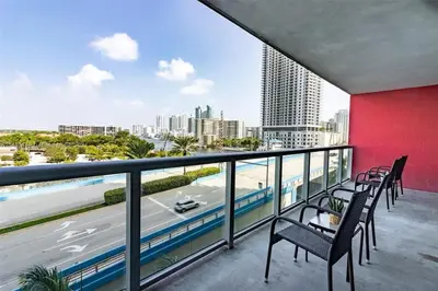 a balcony with chairs and a view of the city at 1 Bdm & Kitchen at Beachwalk Pool Gym Beach in Hallandale Beach