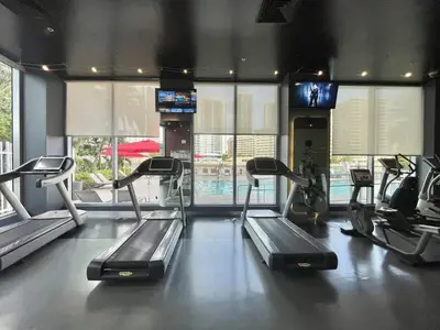 a gym with several tread machines in a room at Modern 1BR w- Kitchen on 30th Floor Epic Views in Hallandale Beach