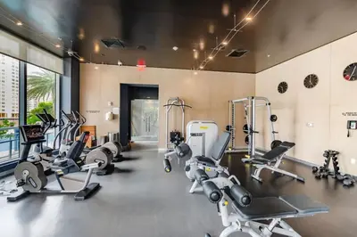 a gym with several treadmills and cardio machines at Modern 1BR w- Kitchen on 30th Floor Epic Views in Hallandale Beach