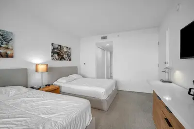a bedroom with two beds and a flat screen tv at Stunning 30th-Floor Studio at Beachwalk Resort in Hallandale Beach