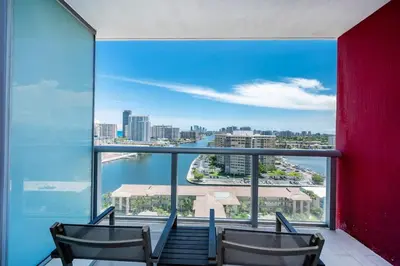 two chairs in a room with a view of the city at Stunning 30th-Floor Studio at Beachwalk Resort in Hallandale Beach