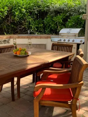 a wooden table and chairs with a plate of fruit on it at Charming 2-BR space in Hollywood in Hollywood