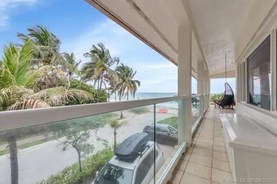 a balcony with a view of the ocean and a car at Charming 2-BR space in Hollywood in Hollywood