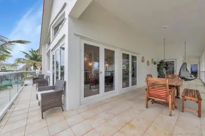 a porch with benches and a table on a house at One - BR spacious beach place in Hollywood