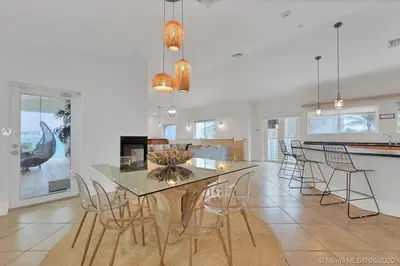 a kitchen and dining room with a table and chairs at One - BR spacious beach place in Hollywood