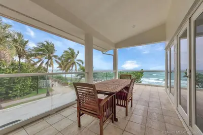 a dining room with a table and chairs and the ocean at One - BR spacious beach place in Hollywood