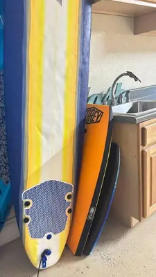 a surfboard sitting next to a kitchen sink at Cozy studio in Hollywood, FL in Hollywood