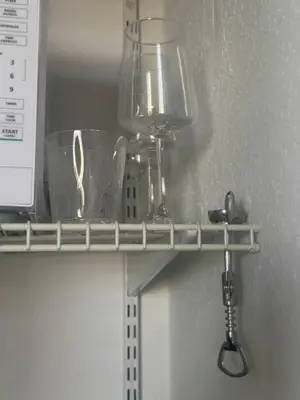 a shelf with glasses and a blender on it at Cozy studio in Hollywood, FL in Hollywood