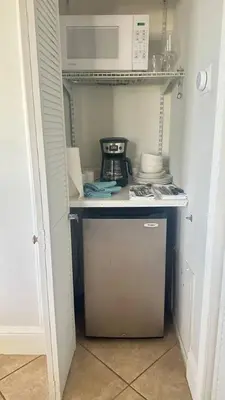 a small kitchen with a stove and a microwave at Cozy studio in Hollywood, FL in Hollywood